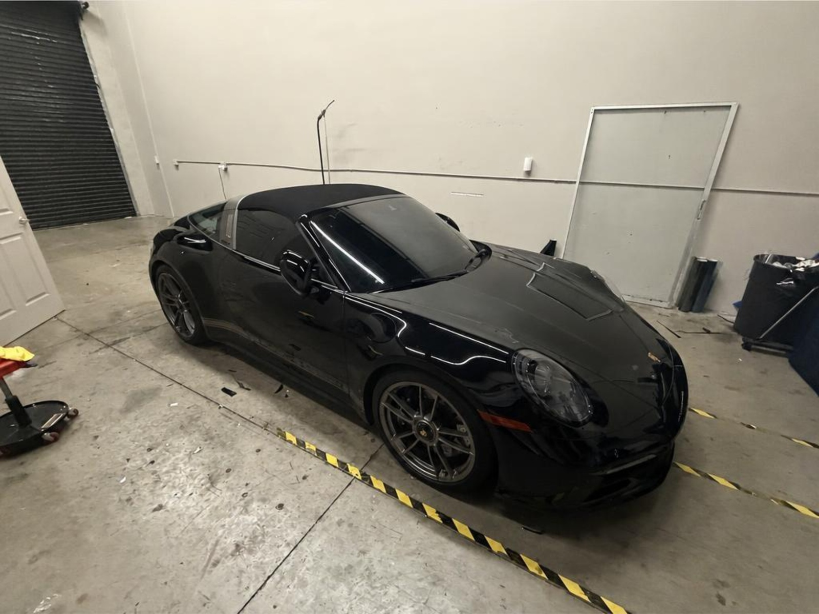 Black Porsche 911 Targa with tinted glass inside the Tamiami Tint of Naples shop